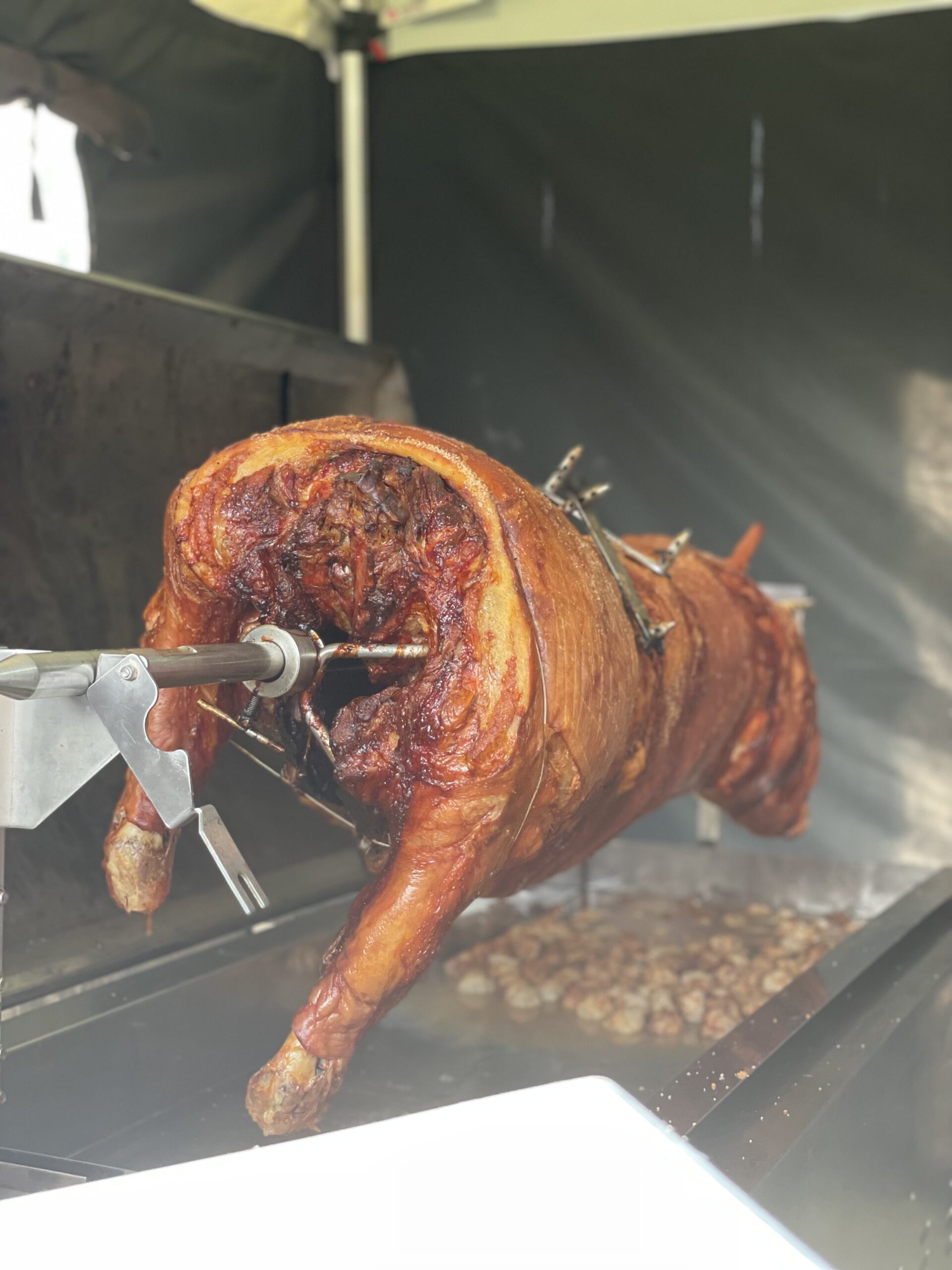 Image shows a hog roast being cooked. Image depicts the Bedfordshire Hog Roast Company